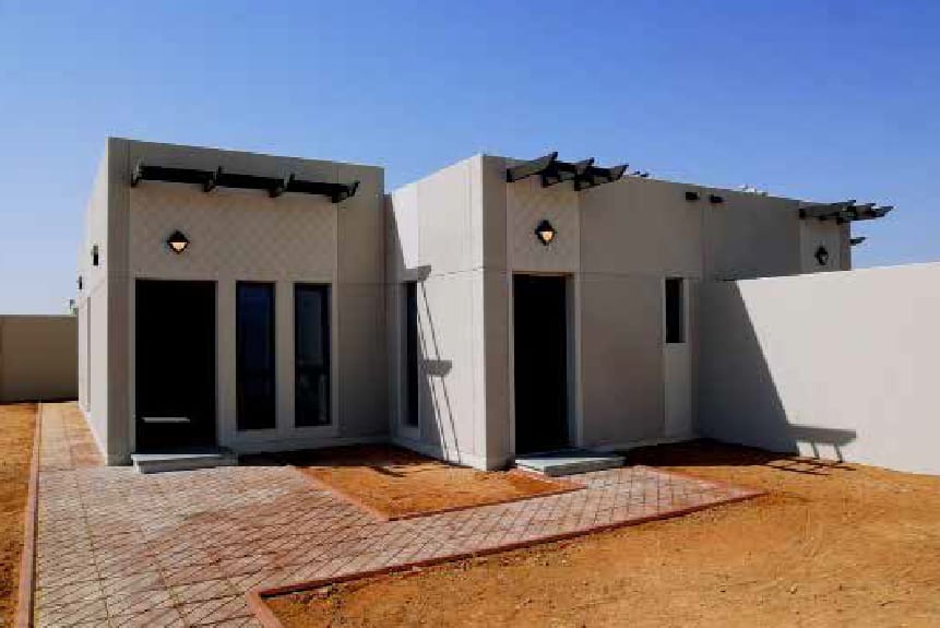 Completed villa unit exterior with paved surround