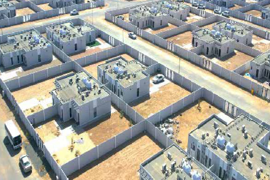 Aerial view of a completed housing compound with landscaped plots