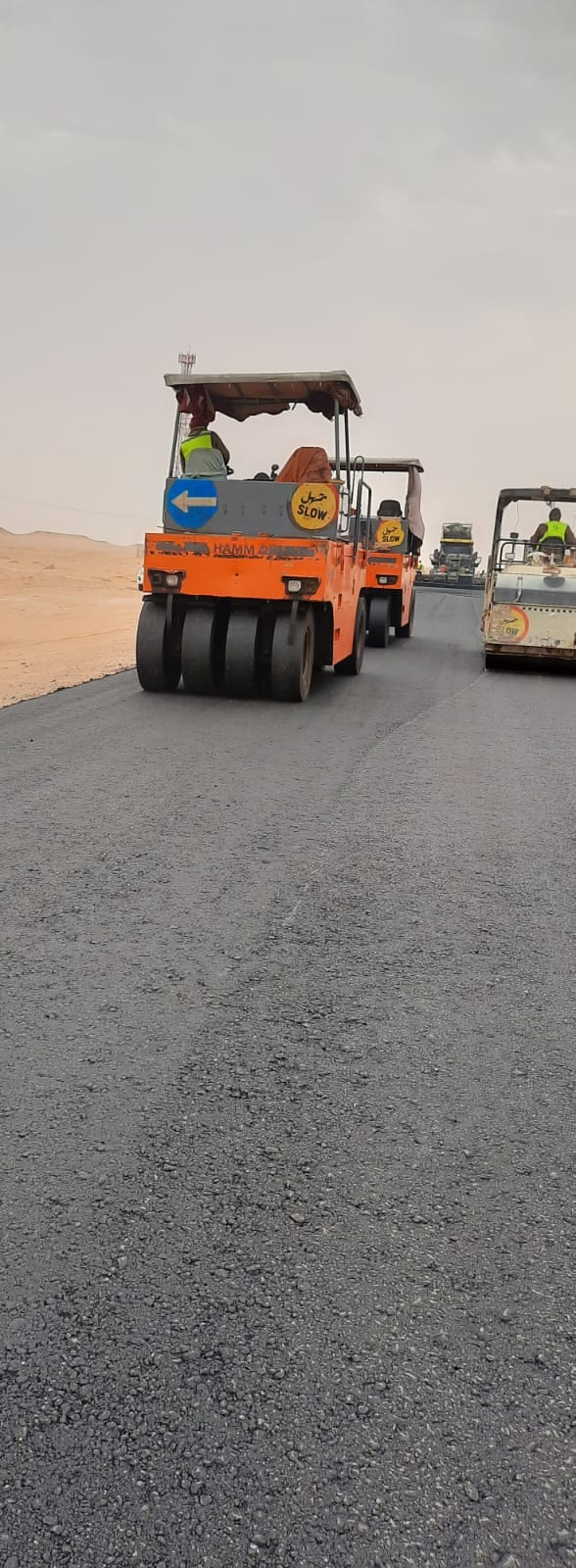 Asphalt paving with compaction rollers