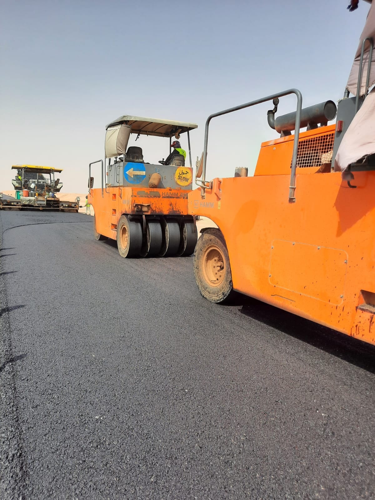 Road construction equipment laying asphalt